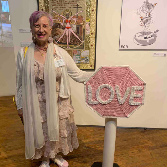 Artist Anne Nordhaus-Bike with Love Sign pink white crocheted stop sign, Chicago gallery opening