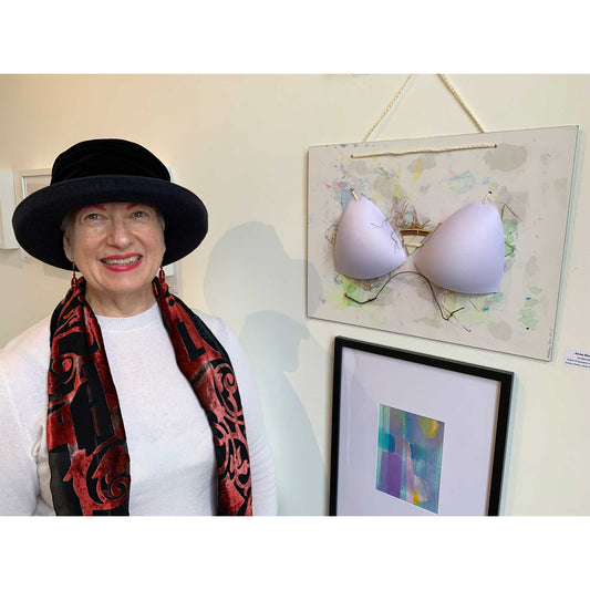 Artist Anne Nordhaus-Bike in hat with her Underwire mixed media bra art at Chicago gallery opening