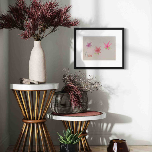 Three bright pink dancing flowers, framed watercolor painting, closeup view on sunny wall