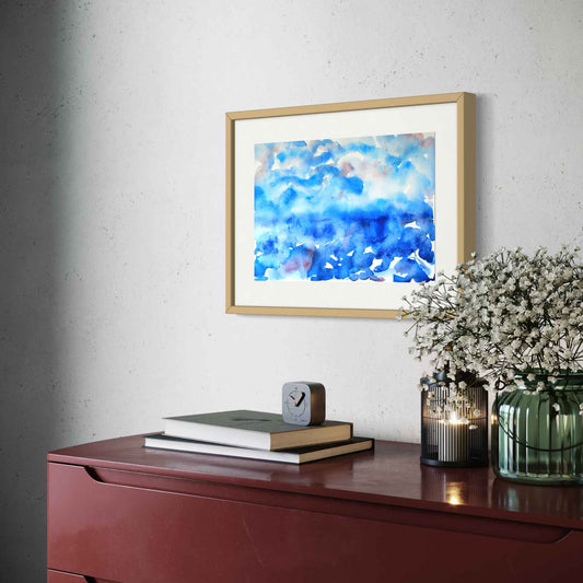 Deep Mystery horizon watercolor, deep blues with red, angled view above cherry wood credenza