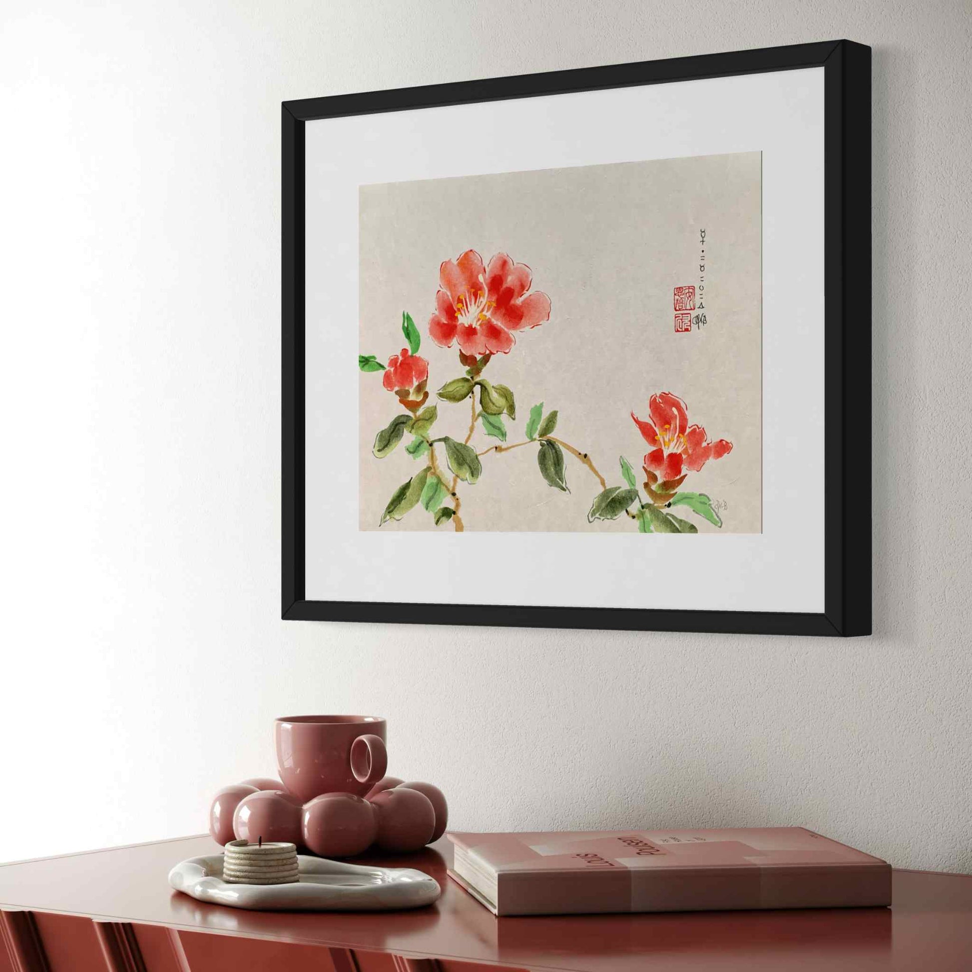 Watercolor painting, framed, of three red flowers, angled closeup view