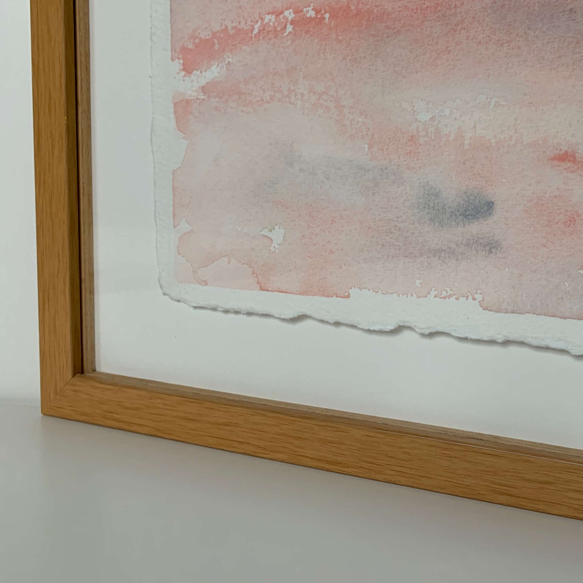 Gentle (Peace) blue, gray, pink horizon watercolor painting closeup, lower left frame corner