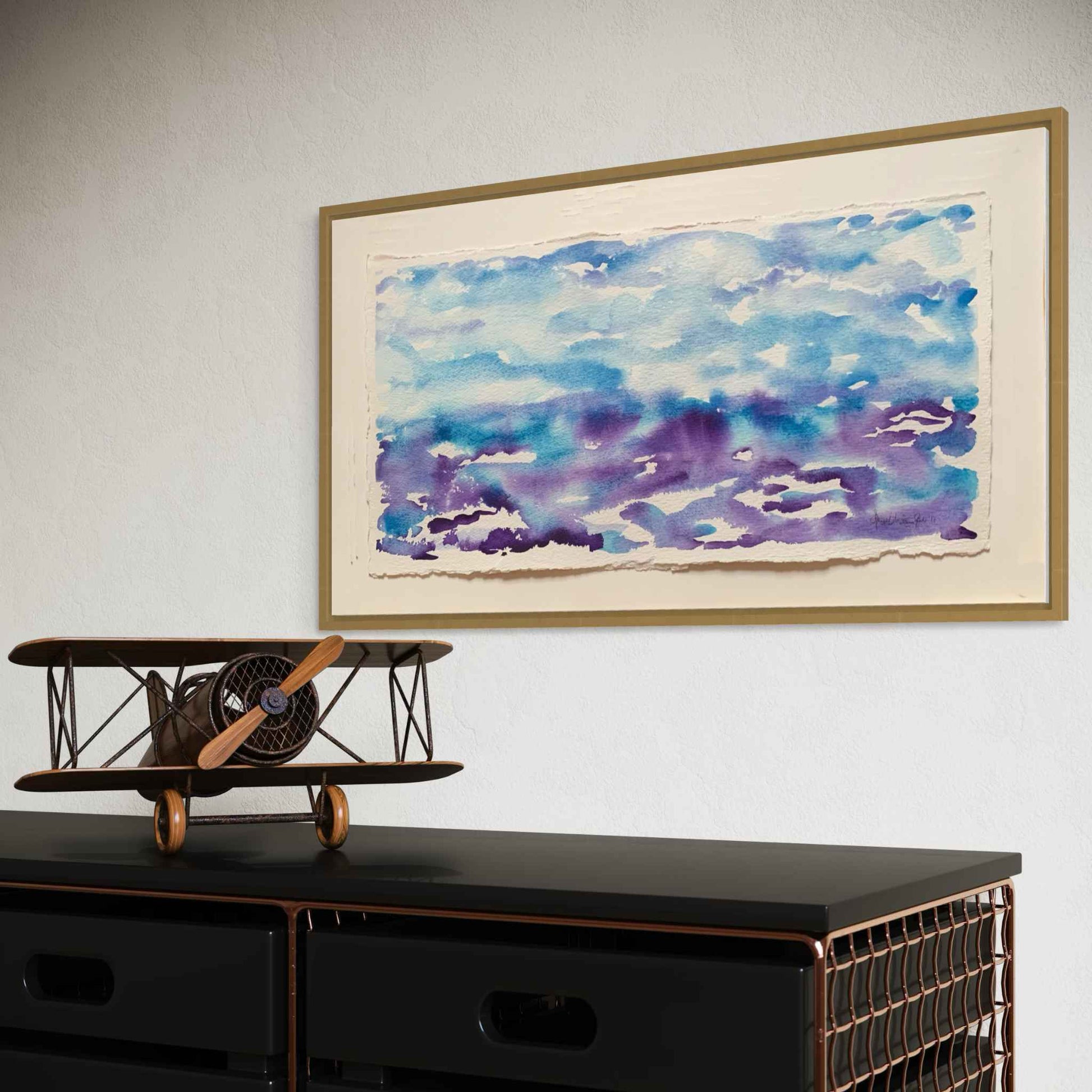 Getting Ready blue purple horizon watercolor painting, angled view, black credenza and model plane