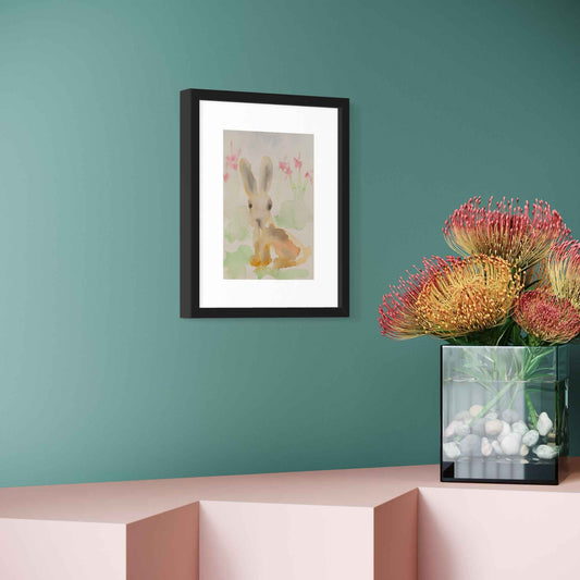 Sweet pastel bunny rabbit watercolor painting, framed, angled view on green wall