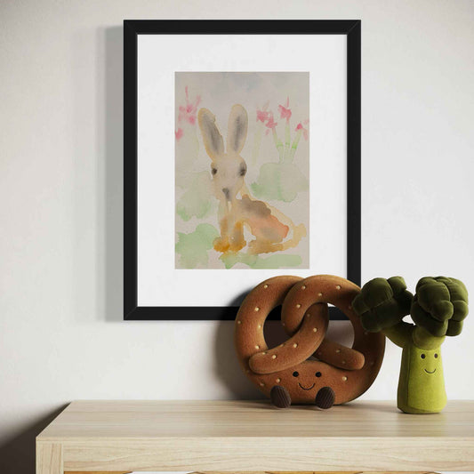 Sweet pastel bunny rabbit watercolor painting, framed, closeup view in childs room above toys