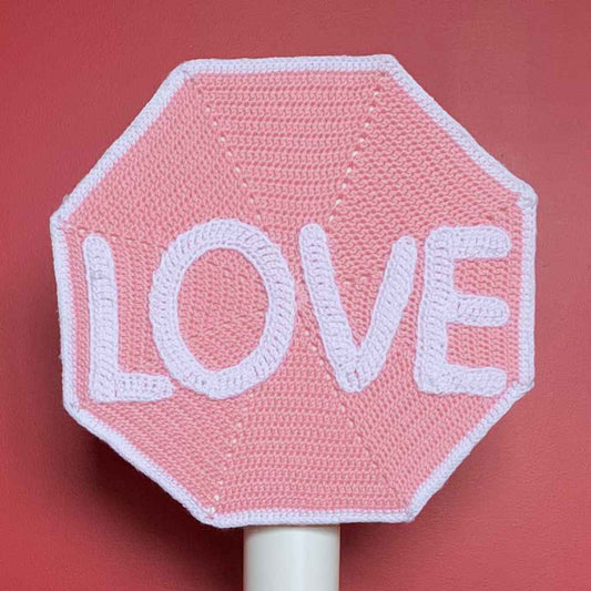 Love Sign pink and white crocheted stop sign mixed media art, closeup view