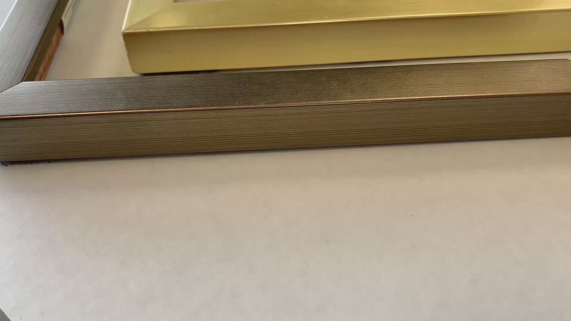 Watercolor painting framing-product video showing metallic frame corners arranged as L shapes
