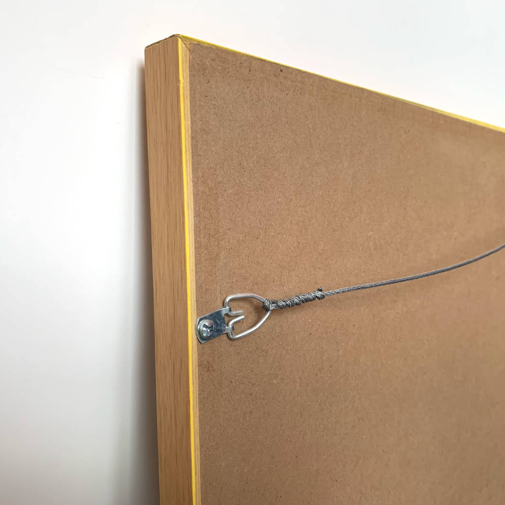 Back view, framed watercolor painting, detail top corner with brown paper, hanging wire, hardware
