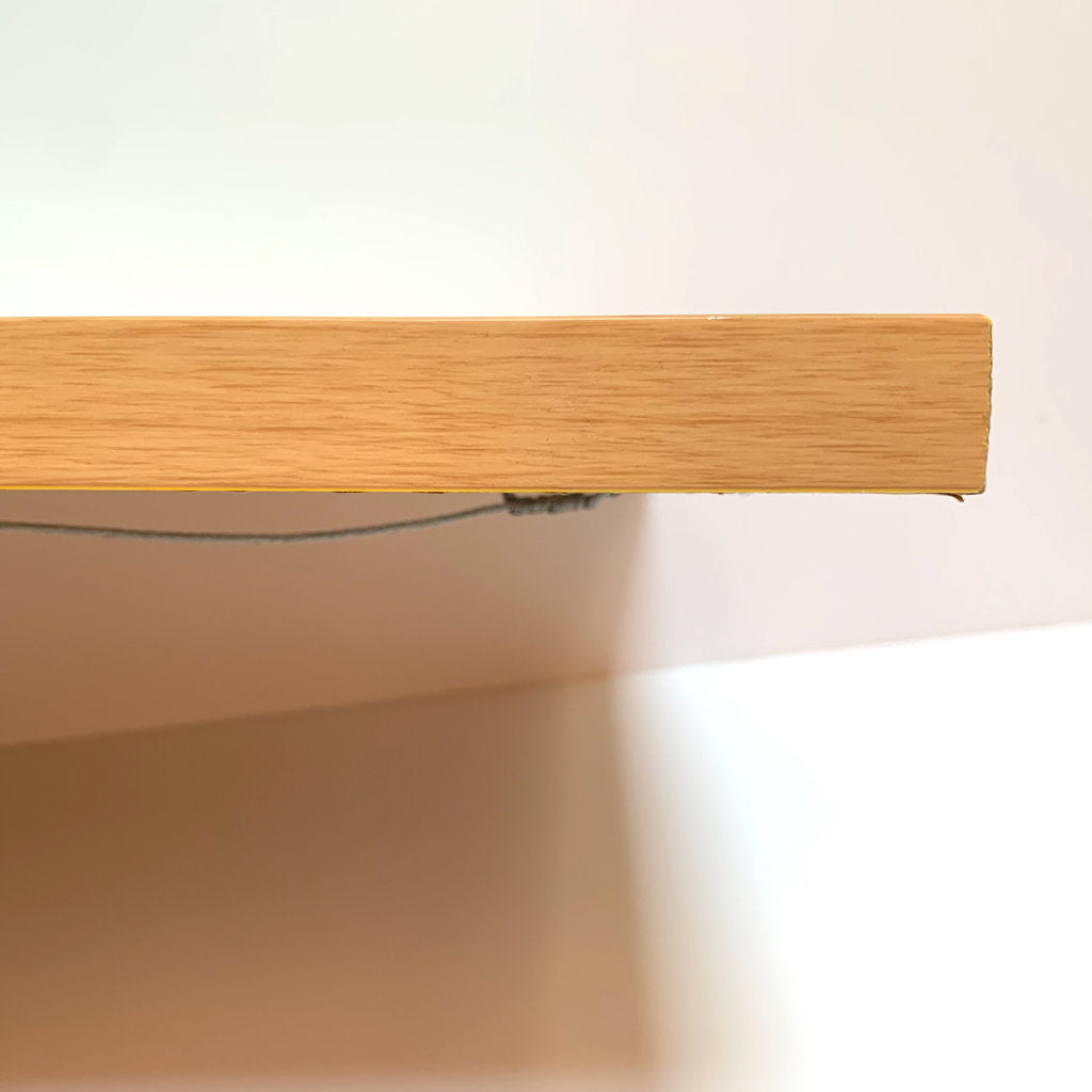 Top edge view detail image for birchwood frame corner, with view of hanging wire on back