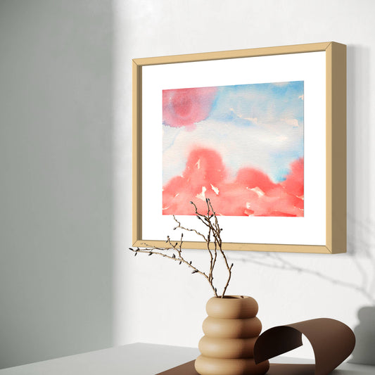 Angled view, Whimsy red and blue horizon watercolor, displayed above tan vase, sunny room