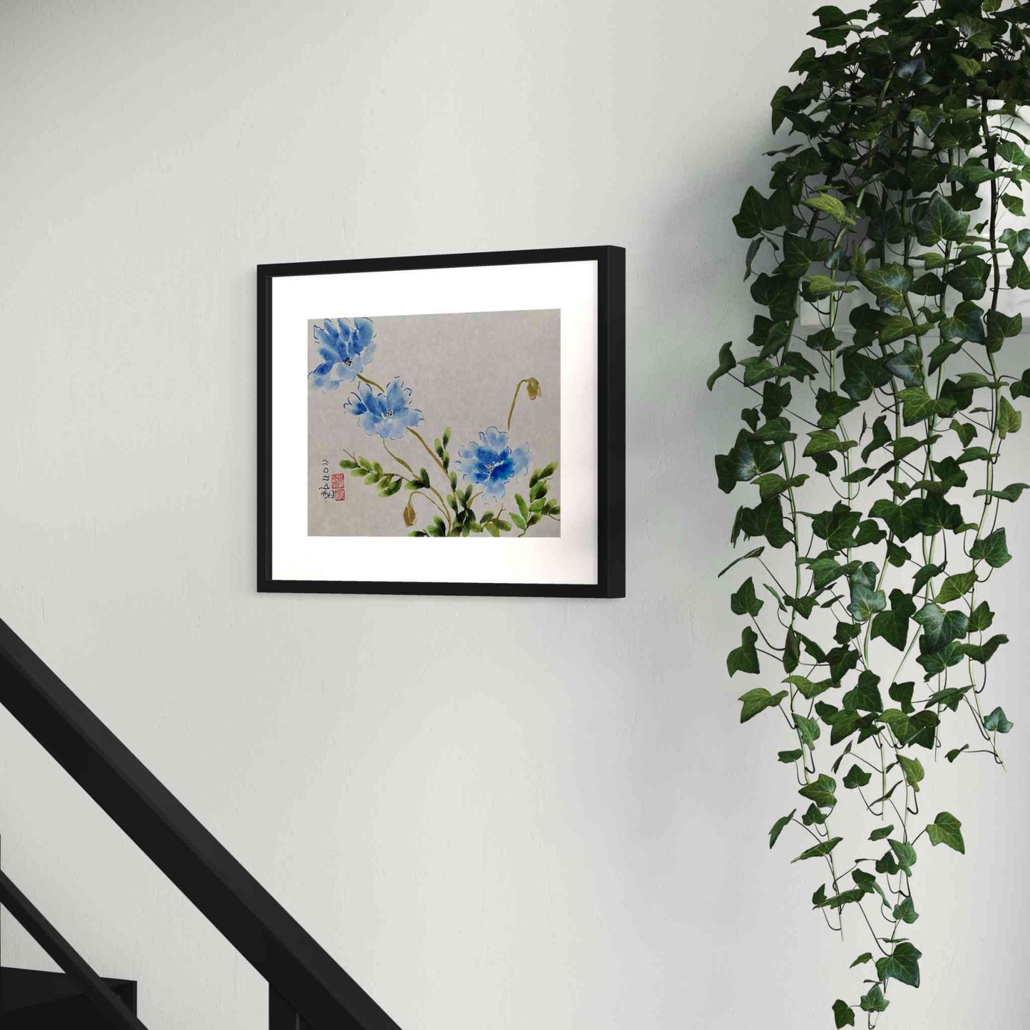 Three blue flowers watercolor painting on stairway wall, next to plant, closeup angled view