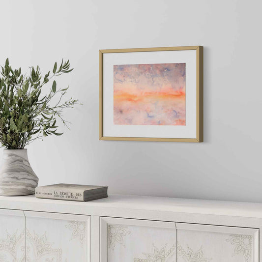 Mystic Stillness orange, blue, and peach framed watercolor, angled view pale gray wall with vase