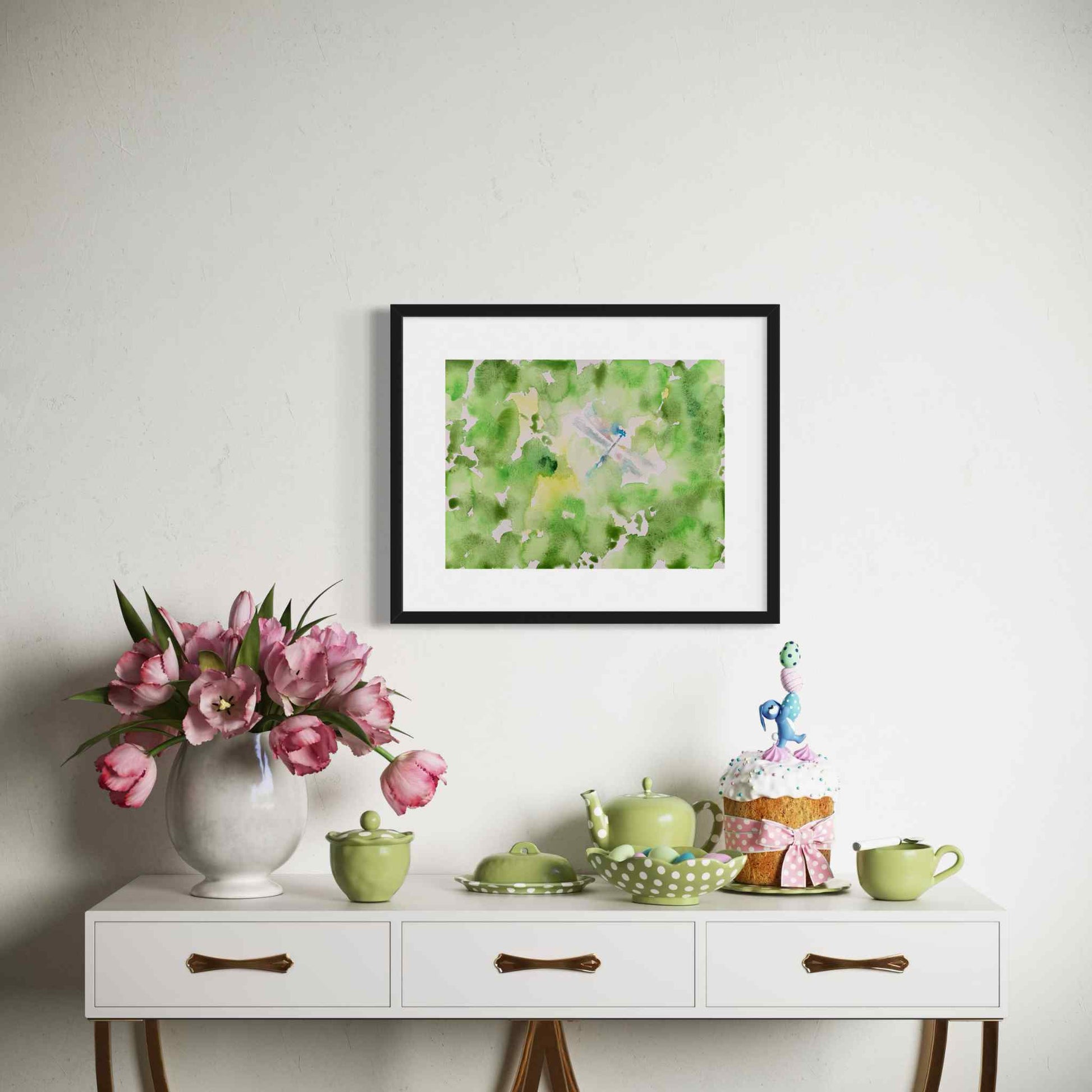 Silver-blue dragonfly in green garden, framed watercolor painting above side table, green dishes
